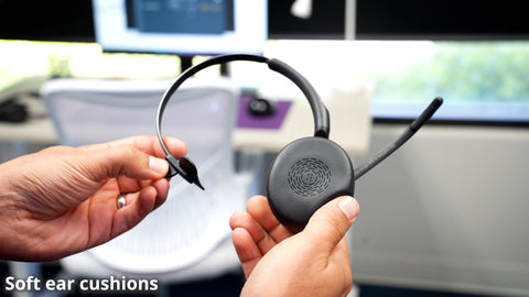 man holding a Jabra Evolve2 55 mono bluetooth headset squeezing softly on ear cushion with the words soft ear cushions imprinted at the bottom  of the image
