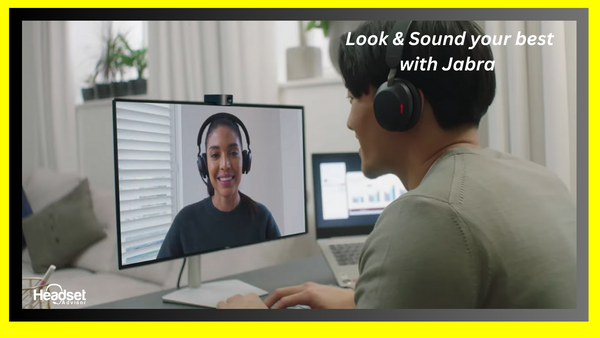 man sitting at desk wearing a Jabra headset on a video call with a woman shown on the computer screen