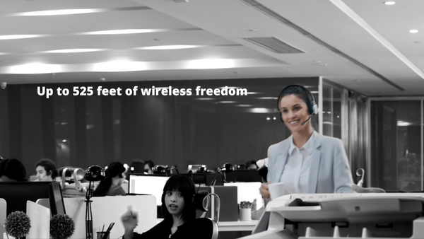 woman in open office walking while talking on a YealinkWH62 wireless headset