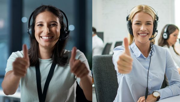 two women pointing thumbs up while working in an  office