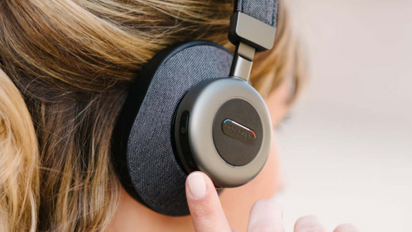 close up view of a woman wearing the Orosound Tilde Pro wireless headset