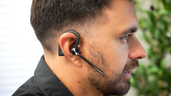 Side view of a man wearing a Yealink BH71 wireless headset