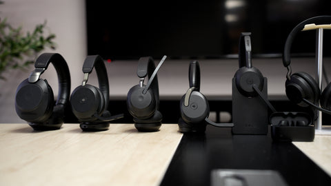 a lineup of Jabra Evolve2 wireless headsets resting on a table