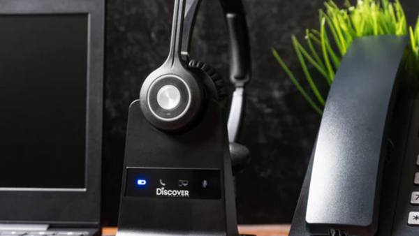 image of Discover Adapt 30 in base, next to computer and desk phone