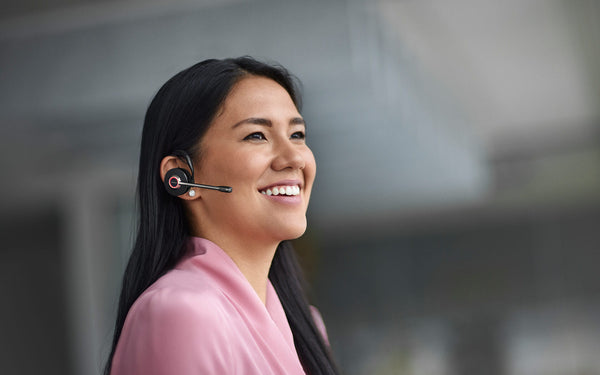 woman wearing a jabra Engage 55 earpiece and smiling