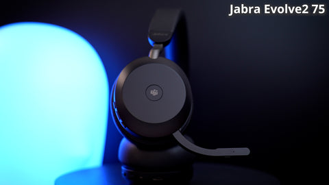 Jabra Evolve2 75 sitting on a desk with a very colorful background