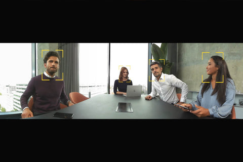 group of people on video call at conference table