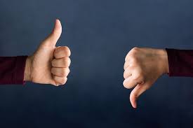 Image of two hands with one thumb pointing down,  and the other hand thumb  pointing up
