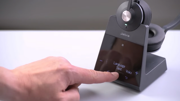 hand and finger pointing at the display screen built  into the base of the Jabra Engage 75