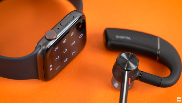 apple iWatch sitting next to the Yealink BH71 earpiece