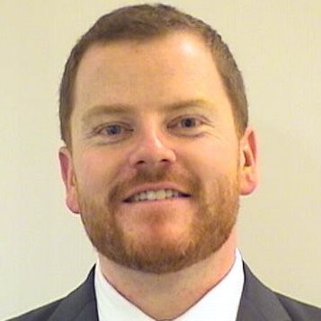 Smiling man with a beard and in a suit