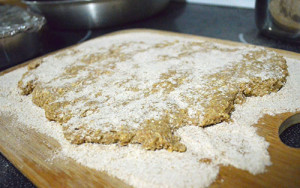 Rolled out dough on surface prepared with flour for homemade dog biscuits 