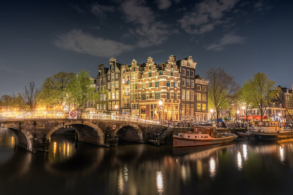 night time view of a bridge and canal in Amsterdam