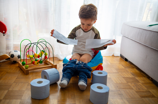 Toddler sitting on his potty as he starts his potty training