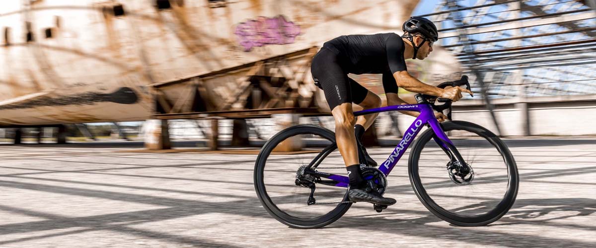 Cyclist riding Pinarello Dogma F Electro Violet 2022 model