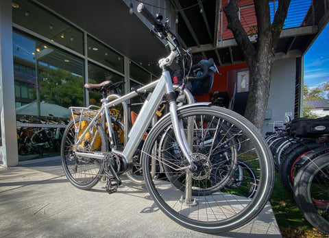 An e-bike correctly locked to a bike rack, with the frame triangle secured.