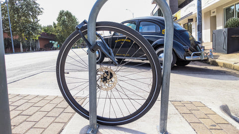 A lonely wheel remains locked to a bike rack after a thief took the rest of the bike. Failing to lock the triangle or inner frame of your bike is one of the most common improper locking methods which leads to bike theft.