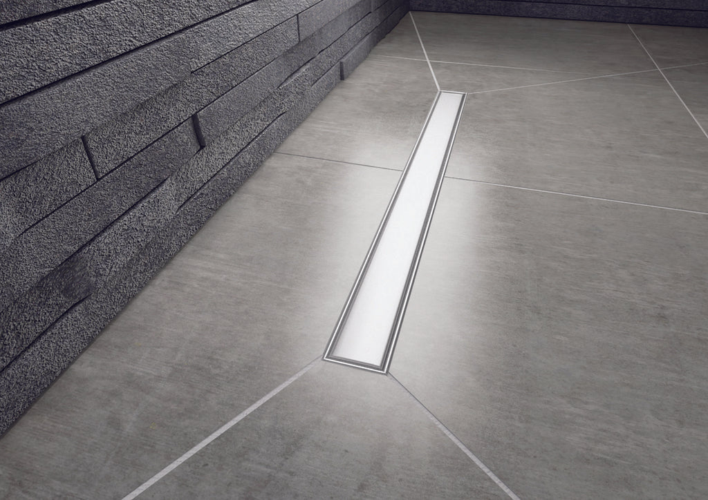  A grey tiled wetroom floor with long rectangular linear style drain in chrome