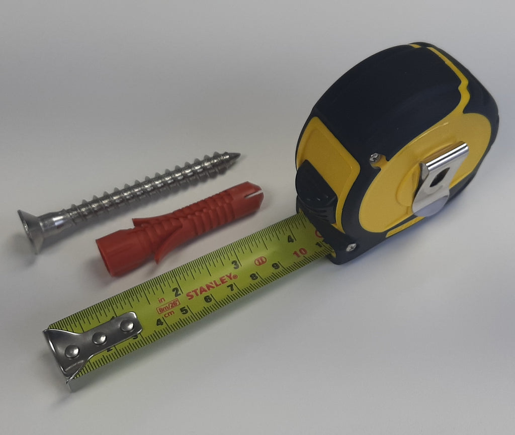  A large screw and rawl plug beside a tape measure, measuring approximately 10cm