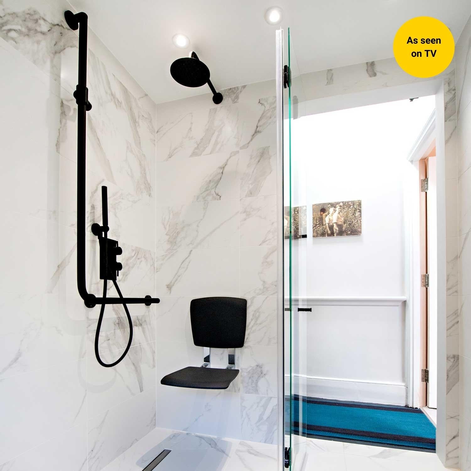 white marble bathroom with Matt Black L-shaped Freestyle shower riser rail and black shower seat