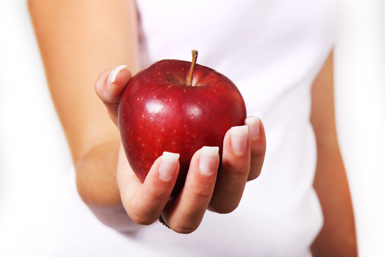 Hand holding apple