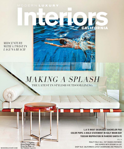 Luxury Interiors California magazine cover, red-and-white modern bed, red small table and photo of woman swimming in pool
