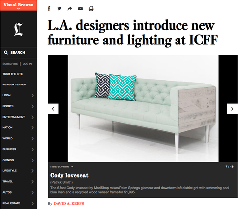 Black-and-white page, print about LA designers' new furniture and lighting, photo of green, modern-style loveseat with pillows