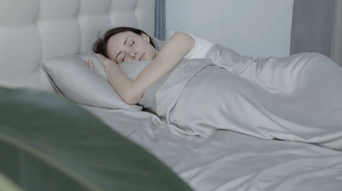 woman sleeping in grey bed