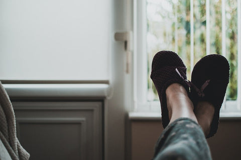 person's feet up with slippers on