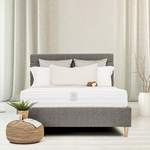 grey bed with pillows and mattress