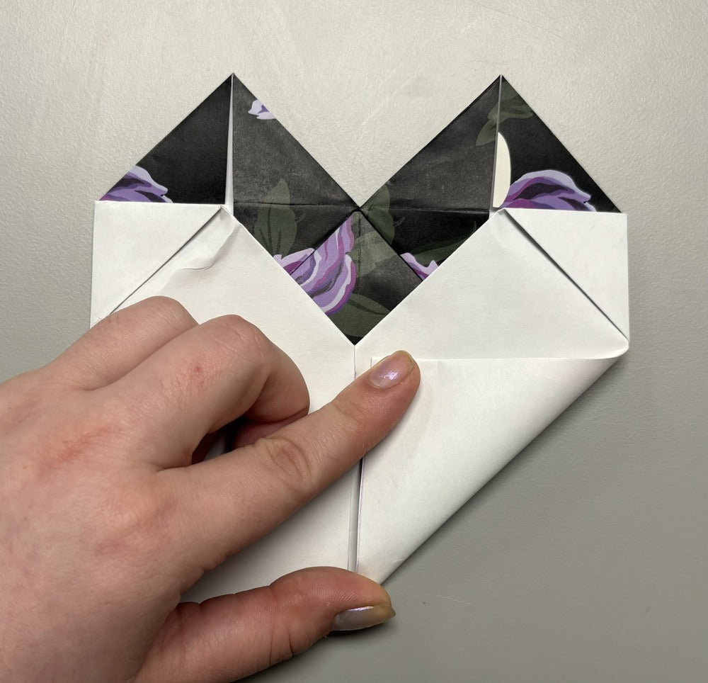 Still on the back of the heart, fold in the bottom flap towards the middle.