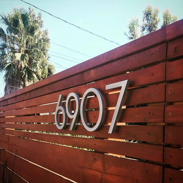 Modern House Numbers 8" Palm Springs numbers, Brushed Aluminum, installed on a stained wood fence