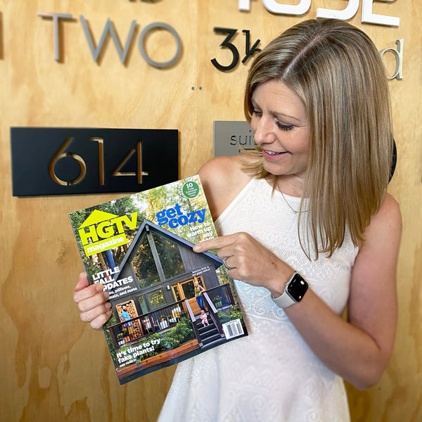 Brandy McLain of Modern House Numbers holding the October issue of HGTV Magazine featuring Jasmine Roth