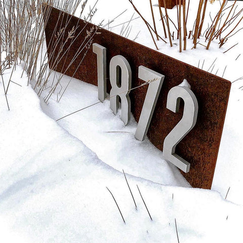 How can you protect your address plaque from the snow?