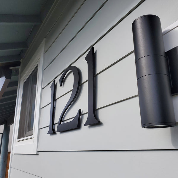 Modern House Numbers, Santa Barbara font, Matte Black finish installed on gray horizontal wood siding.