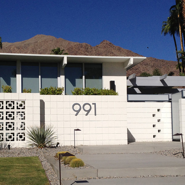 12" Brushed Aluminum Palm Springs Numbers installed on a white masonry site wall, Modern House Numbers