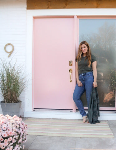 Rebekah Higgs, DIY Mom, stands outside of her MCM home with Palm Springs number '9' from Modern House Numbers in Matte Brass