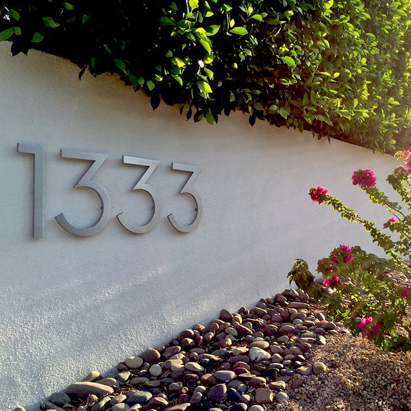 15" Brushed Aluminum Palm Springs Numbers installed on a white masonry wall, Modern House Numbers