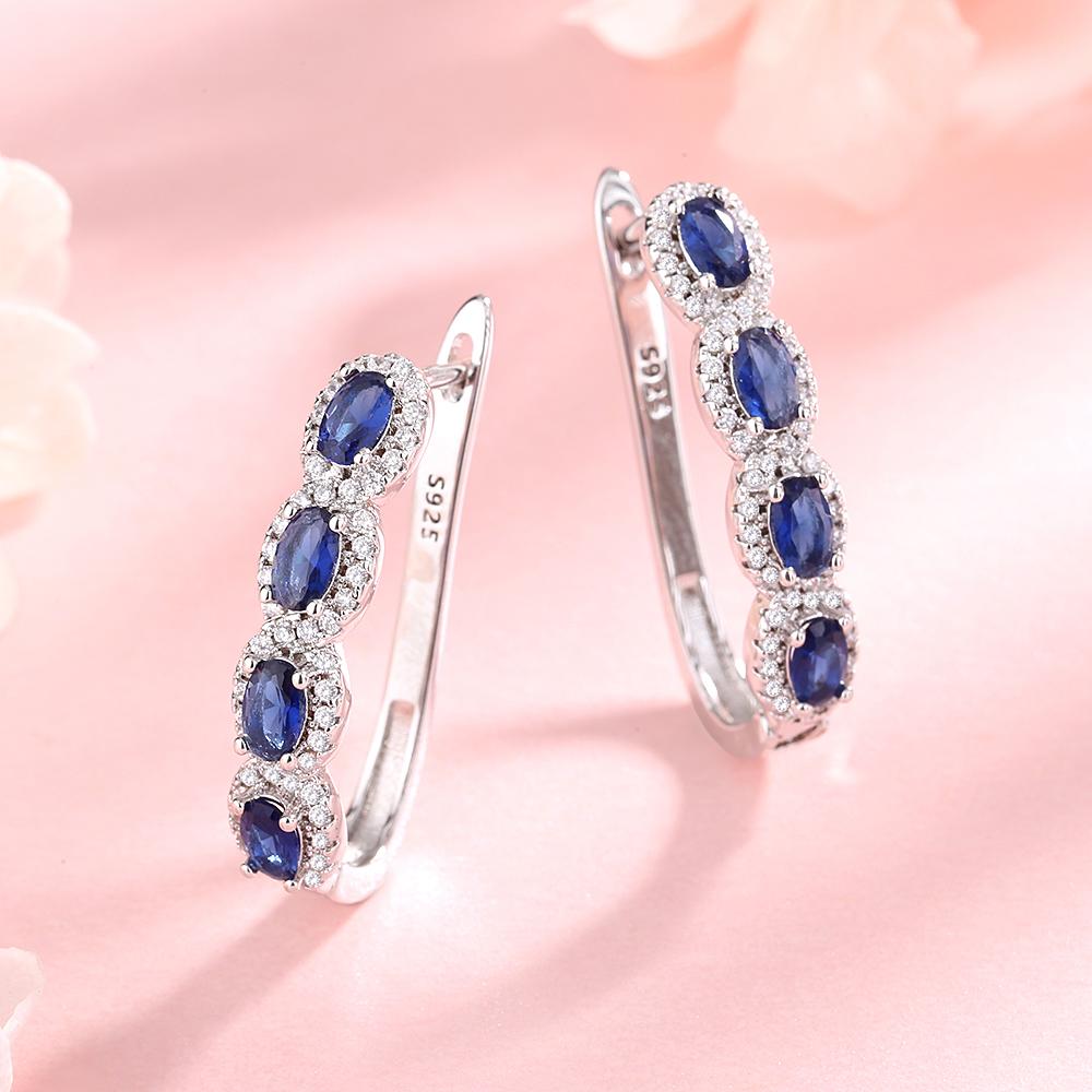 Image of Sapphire Halo Huggie Earrings in Sterling Silver