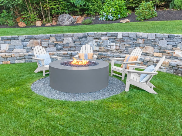 Round Gray Fire Pit on a Grass