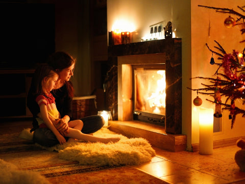 A Mother and Child Sitting By A Fireplace