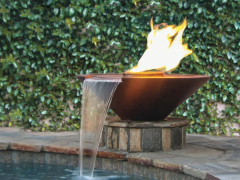 A Copper Fire Bowl With Water Pouring Out To The Swimming Pool