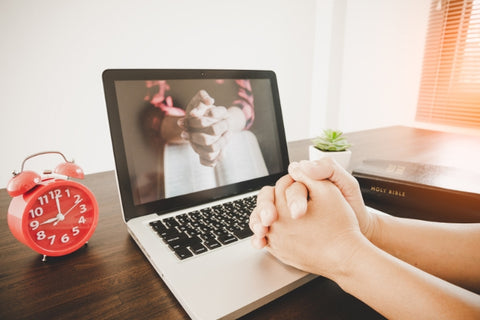 a laptop with a praying hands wallpaper