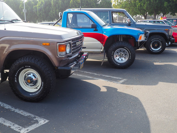 Row of old school Toyota Land Cruiser SUVs and High Lux pickup
