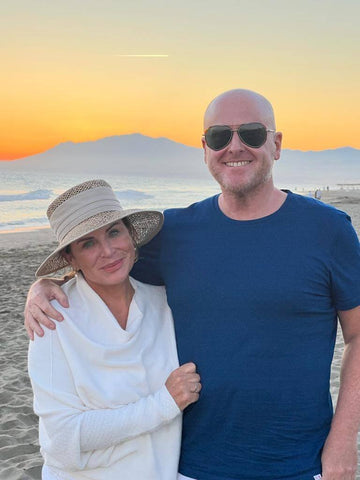 A couple posing for picture on the beach