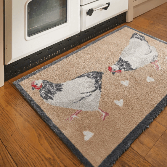 A chicken kitchen floor mat in front of an aga oven