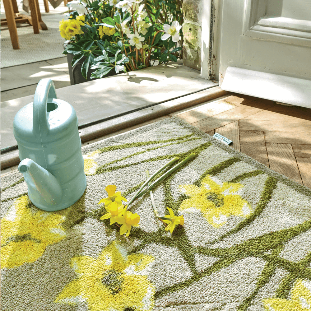 A front door mat with a daffodils on