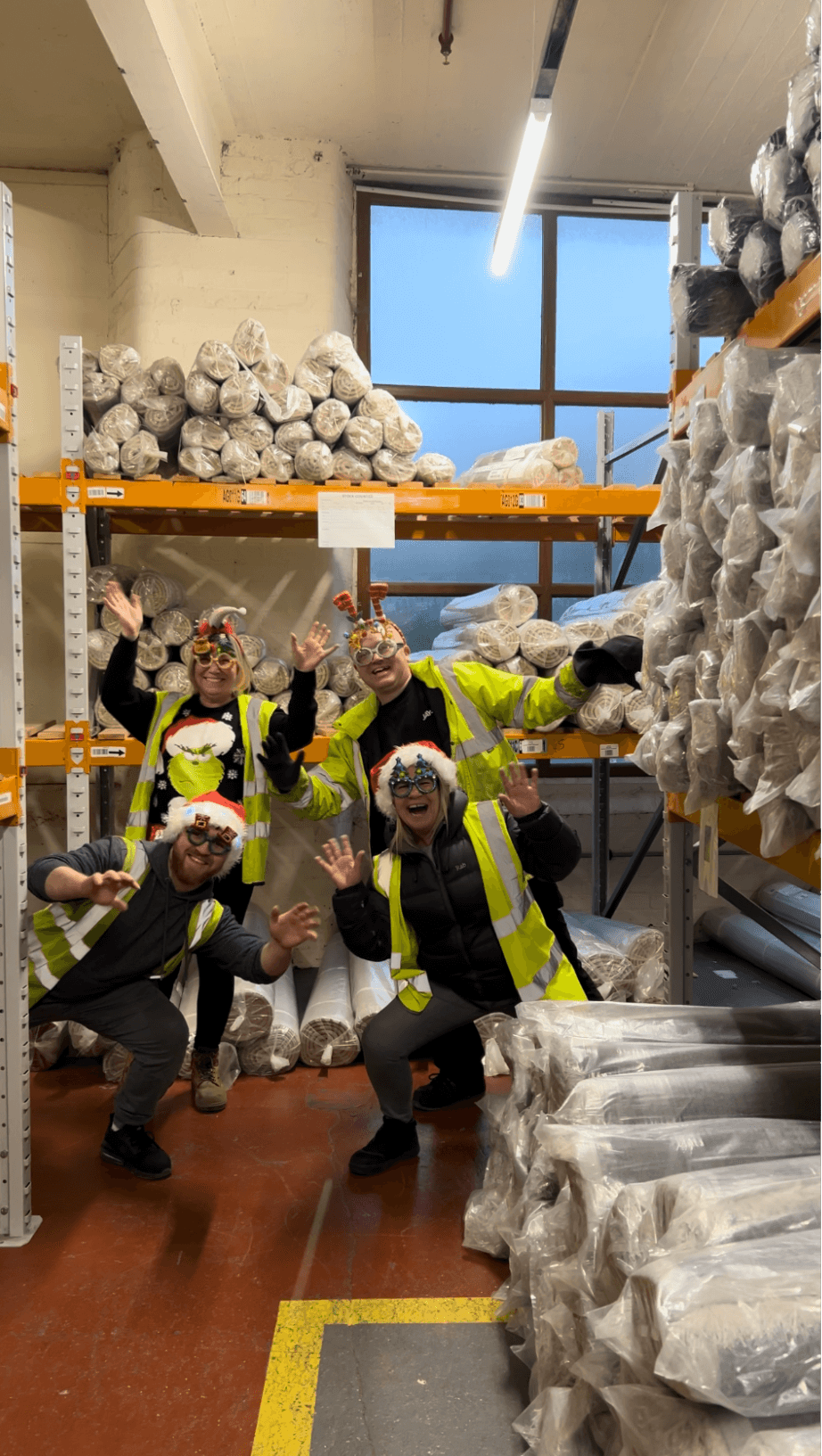 Staff wearing Christmas hats in a factory