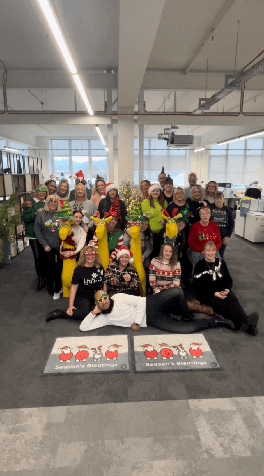 Office staff wearing Christmas jumpers and accessories