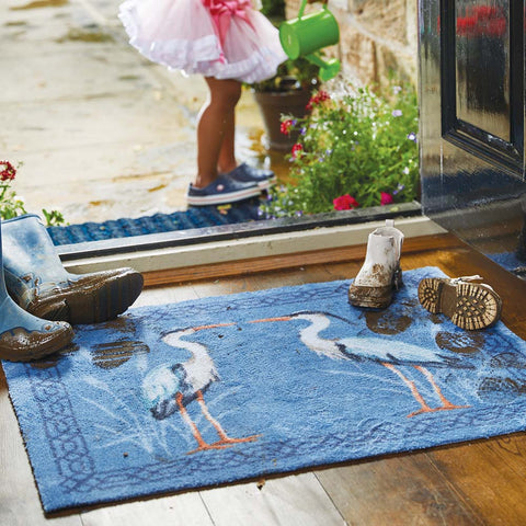Blue rug with two herons on at front door